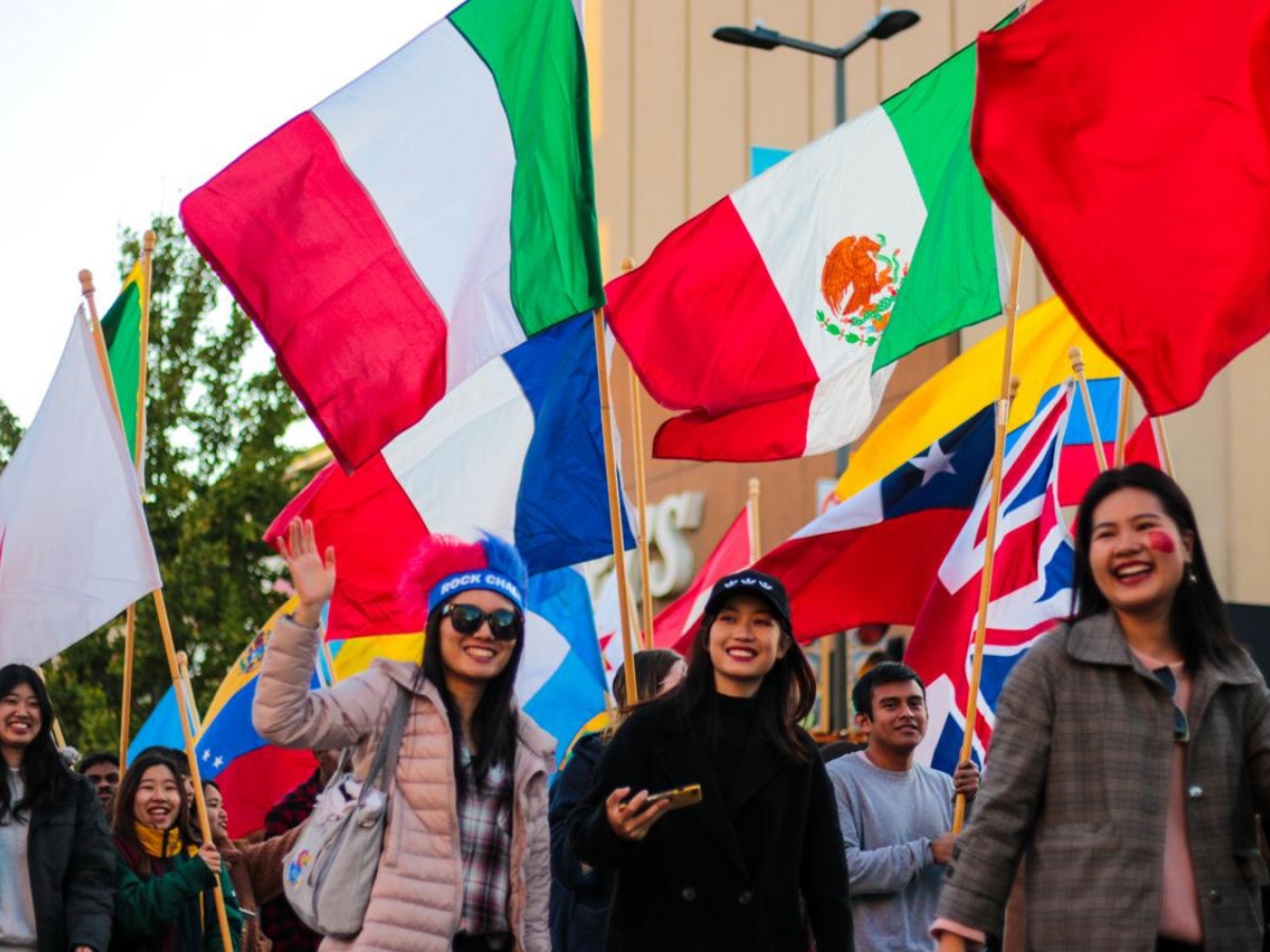 KU Students in parade with international flags