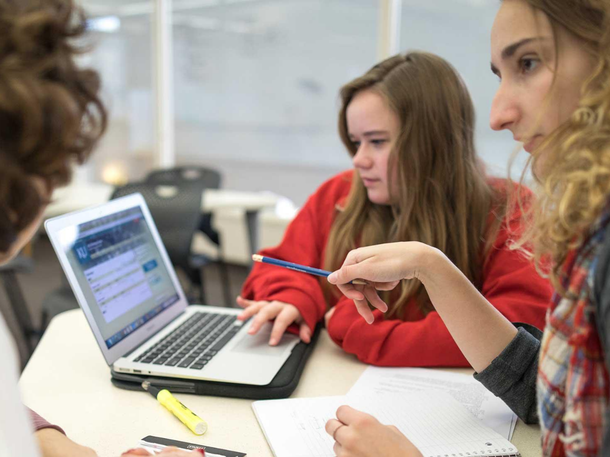 Students looking at a laptop